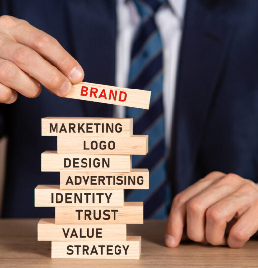 Businessman in suit building from wooden blocks brand concept. Businessman in suit building from wooden blocks brand concept.